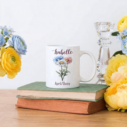 White mug with floral design and text on a stack of books with flowers around