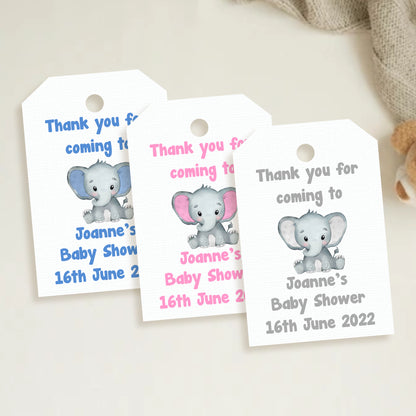 A set of three personalized elephant baby shower thank you tags with different colors and names customized for a baby shower event.
