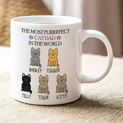 White mug with cat-themed design and text on a textured surface