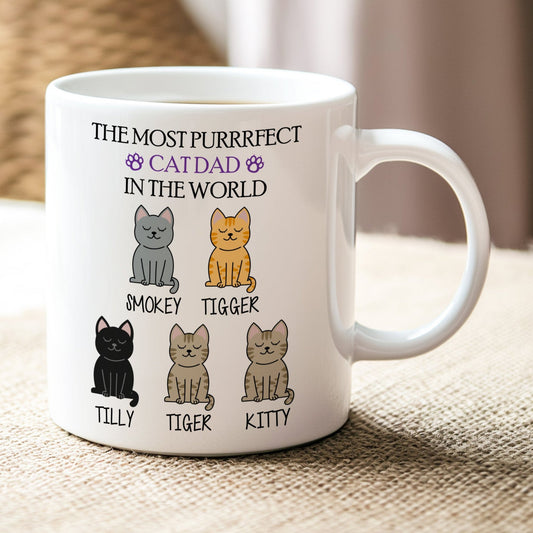 White mug with cat-themed design and text on a textured surface