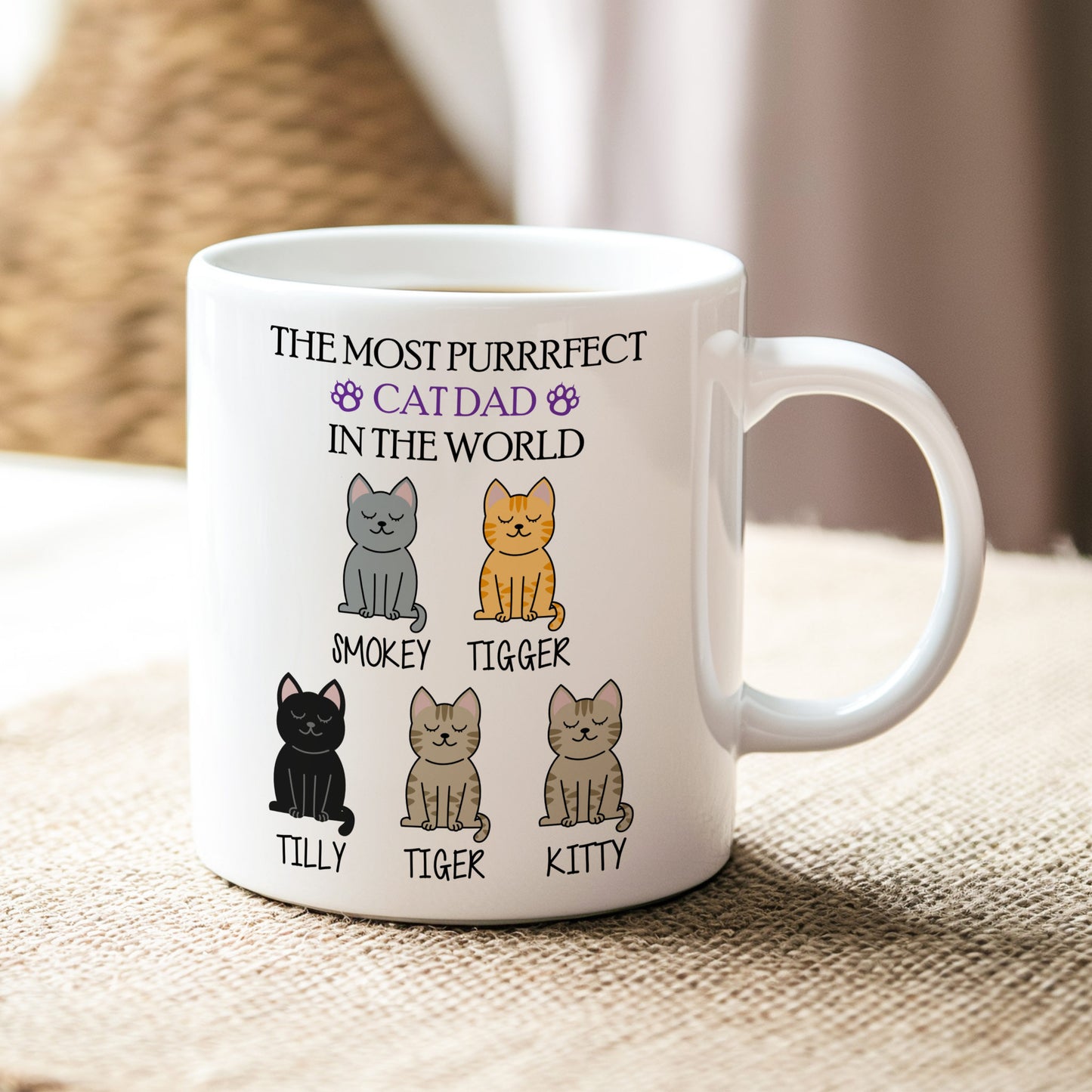 White mug with cat-themed design and text on a textured surface