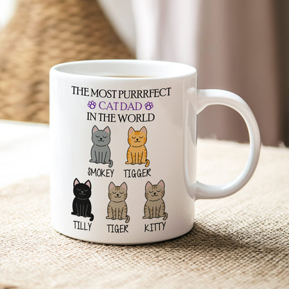 White mug with cat-themed design and text on a textured surface