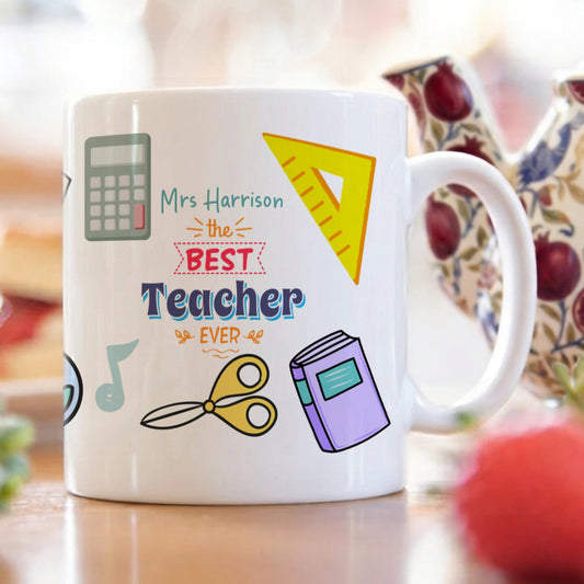 Mug with 'Best Teacher Ever' text and educational icons on a blurred background