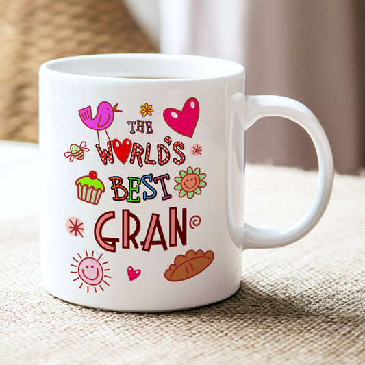 White mug with colorful text and graphics on a textured surface