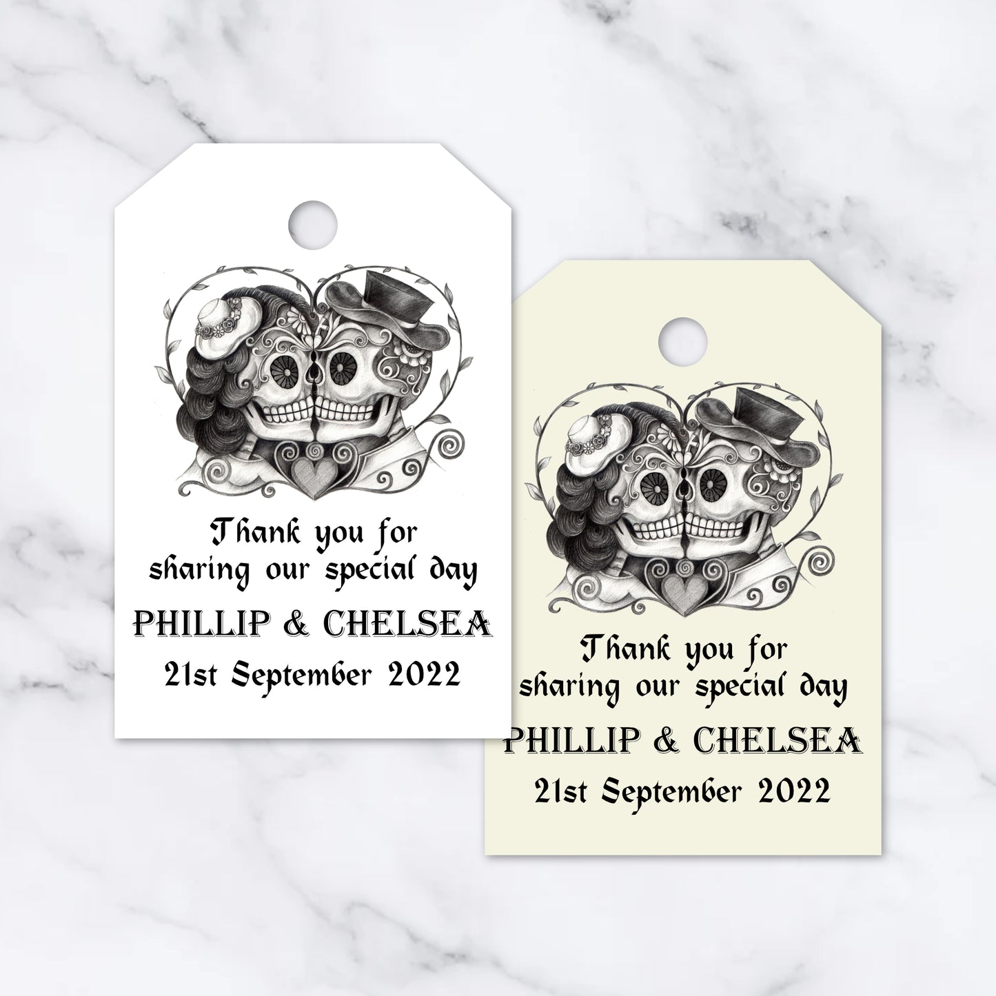 Two customizable gothic-style heart skull tags, with space for personalized text including names and a date, displayed on a white background.