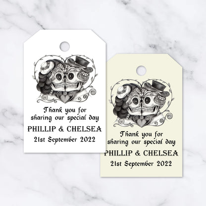 Two customizable gothic-style heart skull tags, with space for personalized text including names and a date, displayed on a white background.